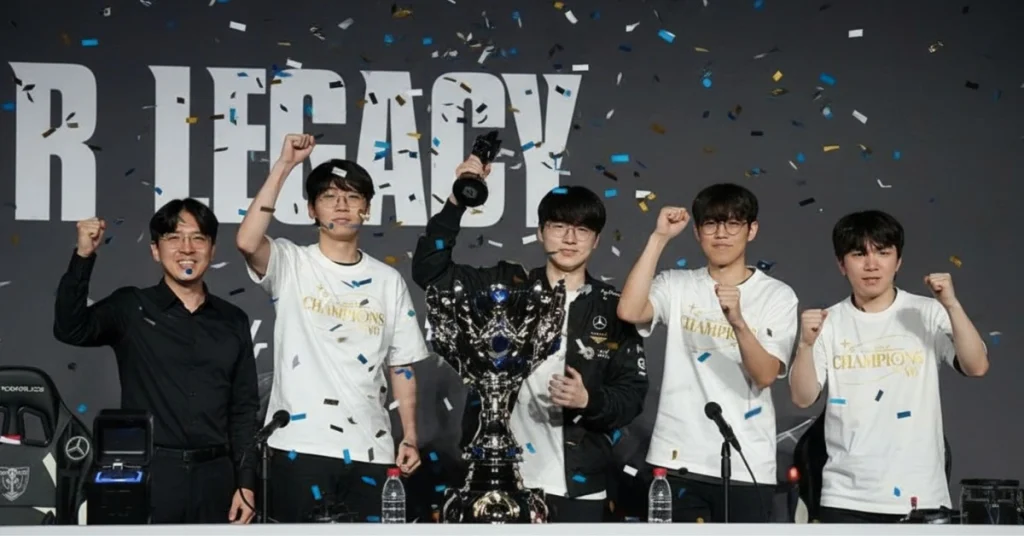 Five individuals celebrate a Valorant championship win with trophies and confetti in a press conference setting.